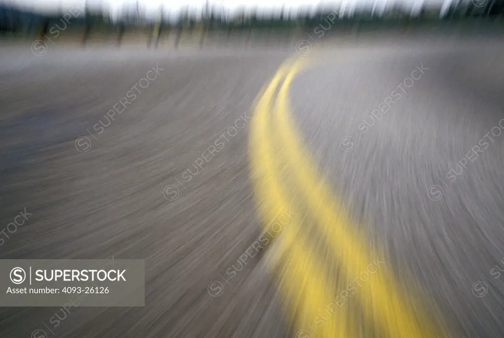 double yellow lines blur asphalt pavement POV curve street