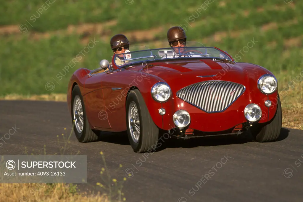 austin-healey 100 1954 old style classic couple ride helmets glasses