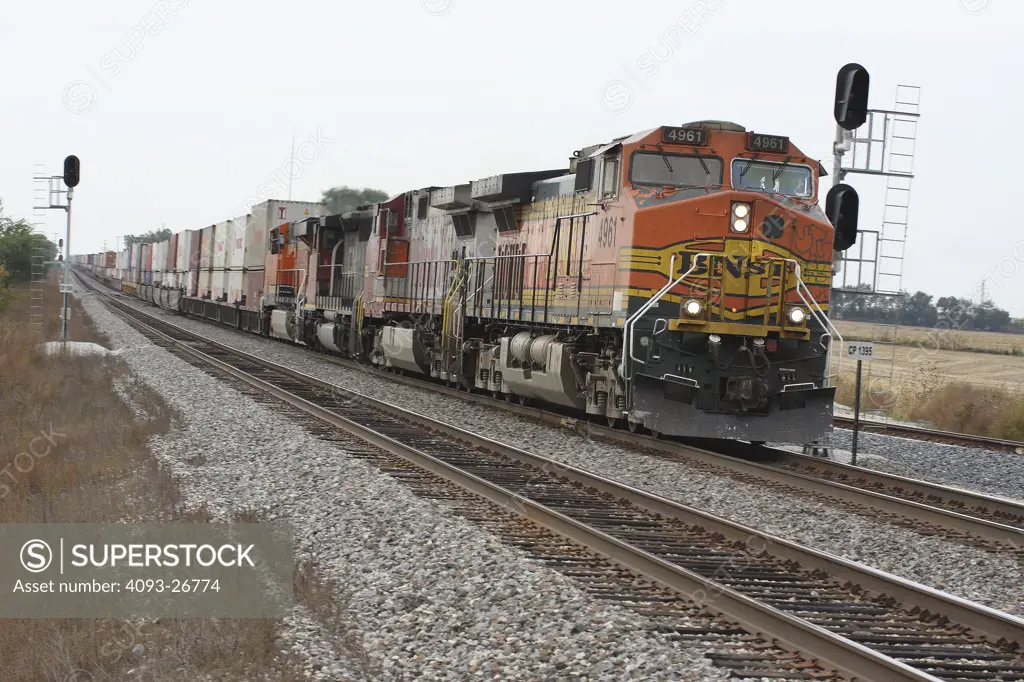 Freight train rolling by in the midwest United States. Burlington Northern Santa Fe Railway BNSF 4961 Double Stack, General Electric C44-9W lead locomotive, eastbound.