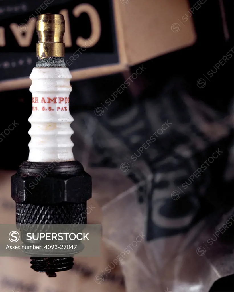 shot in studio,a vintage spark plug with champion package background.