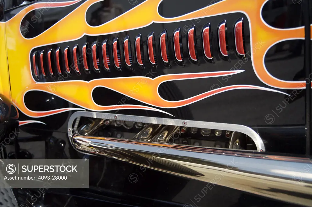 A close up detail shot of a 1930's Chevrolet hot rod engine panel vent exhaust