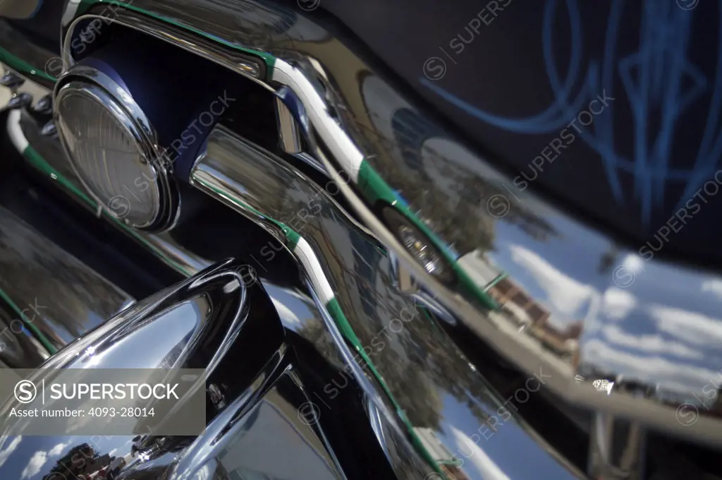 A close up detail shot of a 1953 Chevrolet hotrod paint and pin stripes, and chrome bumper