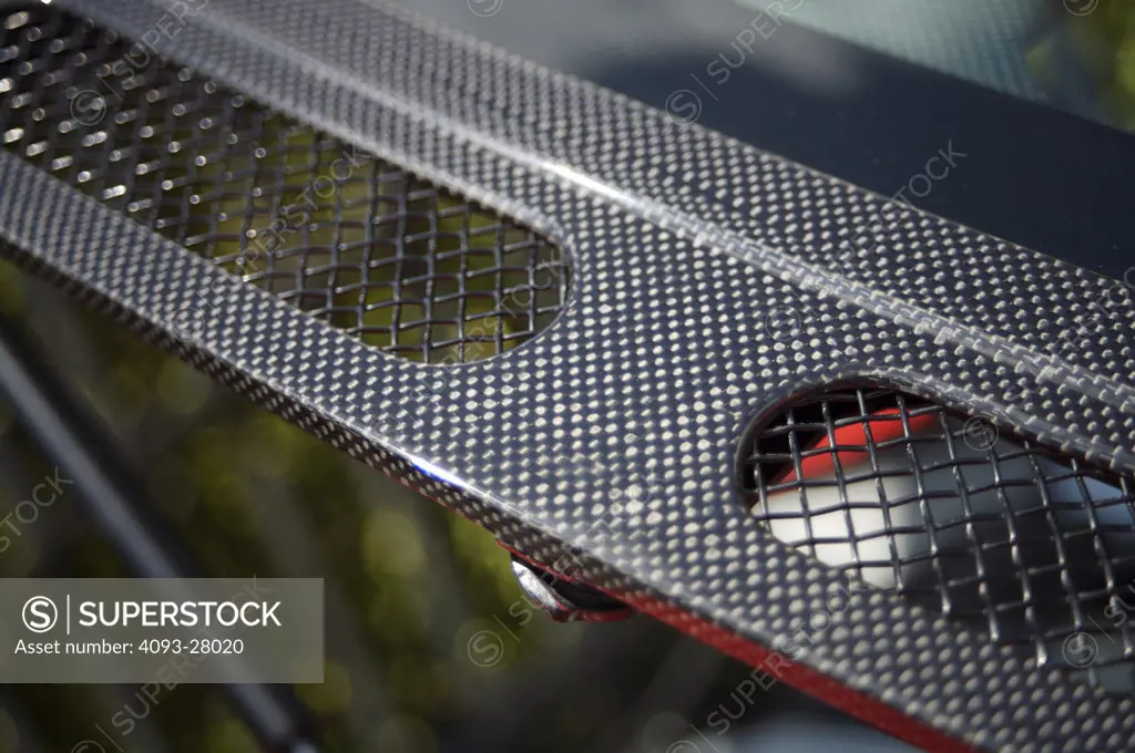 A close up detail shot of a 2006 Ferrari 430 Scuderia carbon fiber