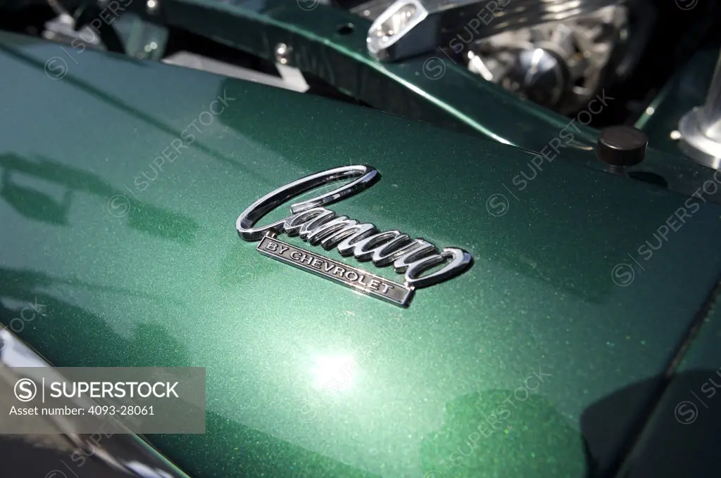 A close up detail shot of an old green Chevrolet Camaro