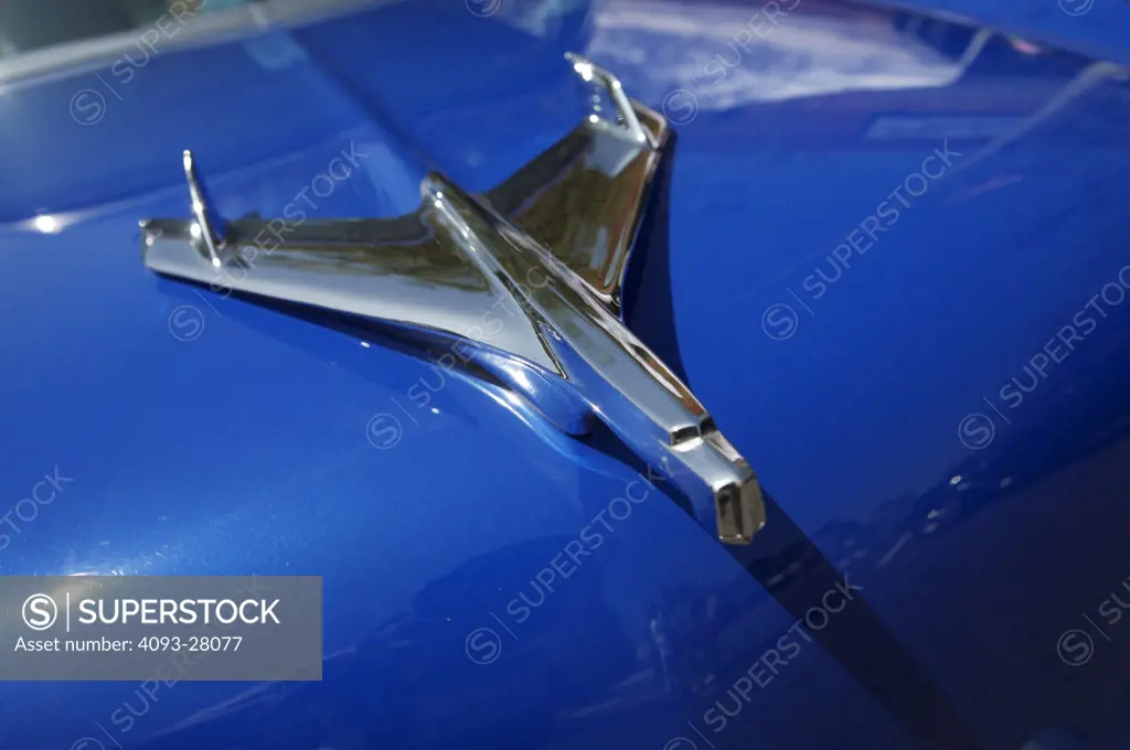 A close up detail shot of a 1958 Chevrolet Bel Air hood ornament