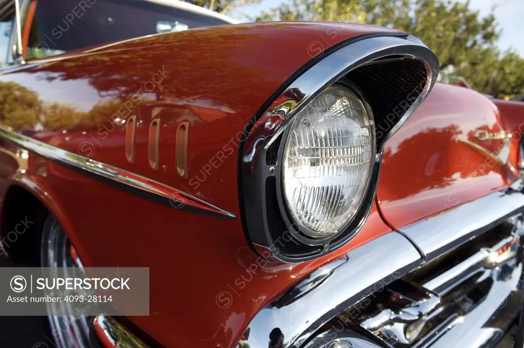 A close up detail shot of a 1957 Chevrolet Bel Air headlight