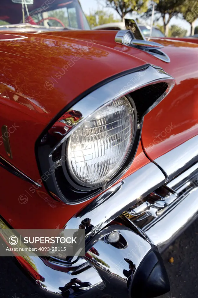 A close up detail shot of a 1957 Chevrolet Bel Air headlight