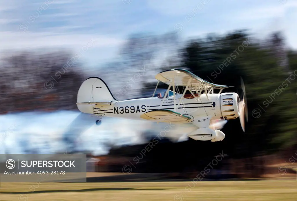 2010 Waco Classic test aircraft taking off from airstrip, side view