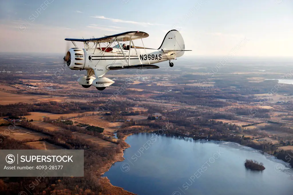2010 Waco Classic test aircraft in flight over rural countryside, side view