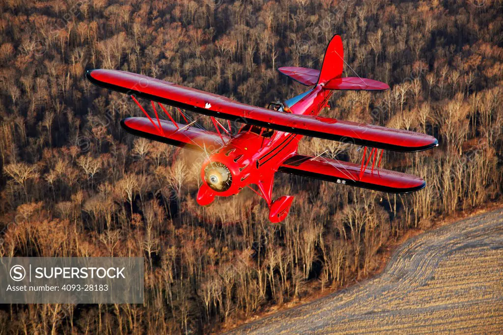 2010 Waco YMF-5D flying over rural countryside, high angle view