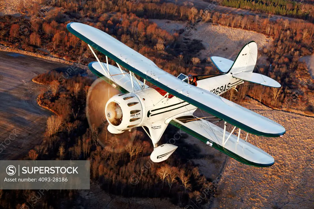 2010 Waco Classic test aircraft in flight over rural countryside