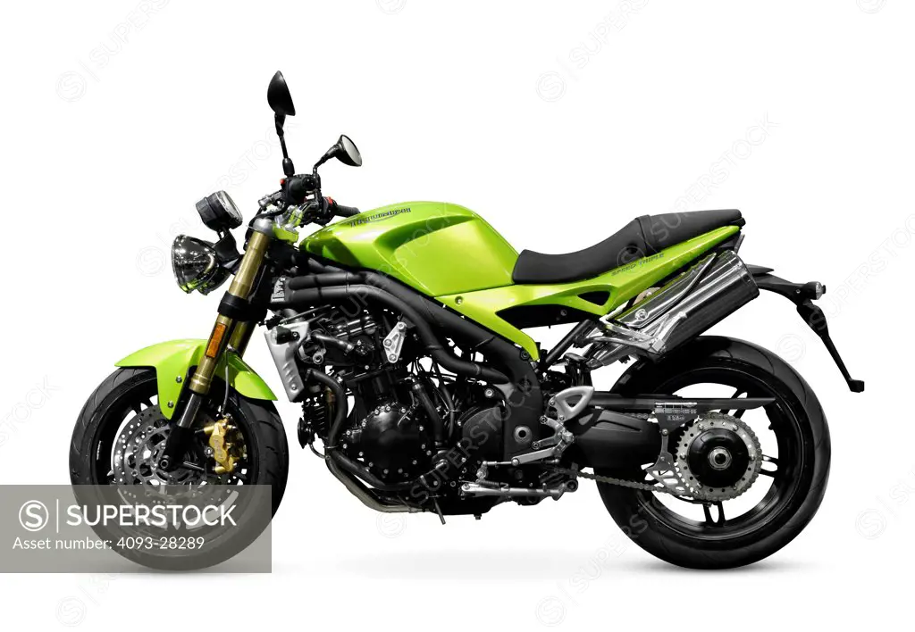 Static profile view of a green 2008 Triumph Speed Triple streetfighter motorbike in the studio