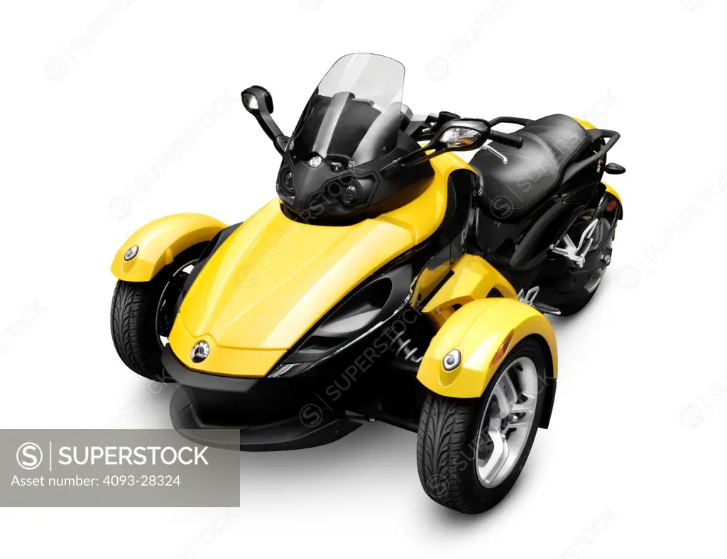 Static front 3/4 of a yellow 2009 BRP Can-Am Spyder Roadster three-wheeled vehicle in the studio