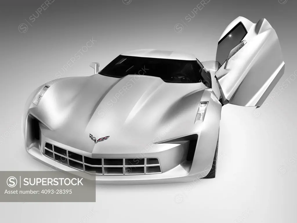 Front static view of a silver 2012 Chevrolet Corvette Stingray concept sports car in the studio, with butterfly door open