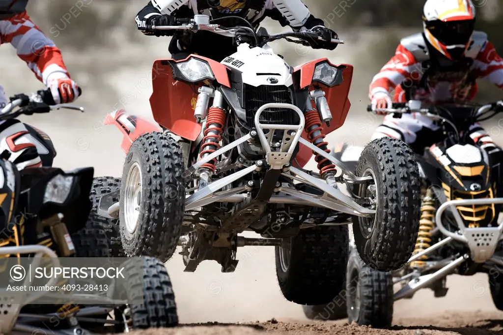Front 3/4 action of a group of 2010 Can-Am Quad ATV racers on a dirt race course