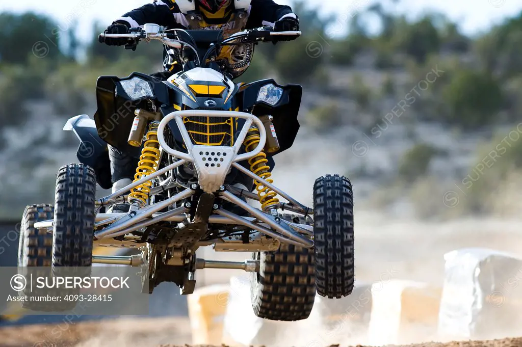 Front 3/4 action of a 2010 Can-Am Quad ATV on a dirt race course