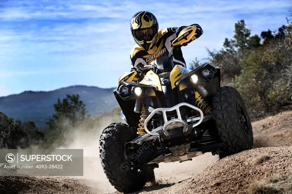 Front 7/8 action of a 2010 Can-Am Quad ATV on a rural, tree lined trail