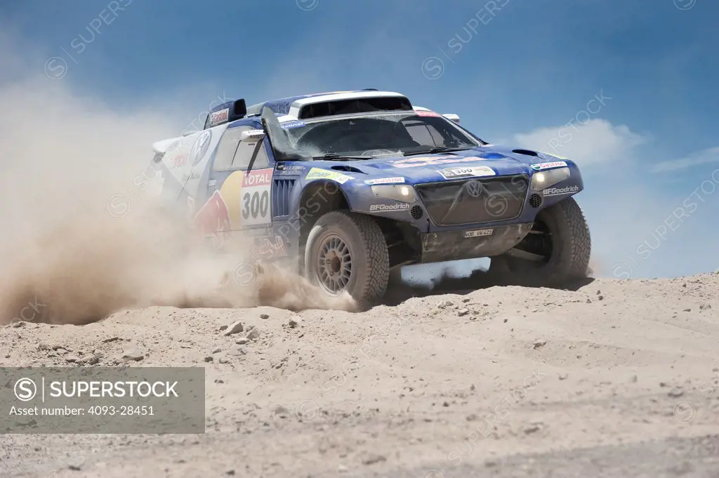 Front 3/4 action of Mark Miller racing his Volkswagen Touareg Off Road Racer on a rocky desert road in Argentina during the Dakar Rally race of 2010