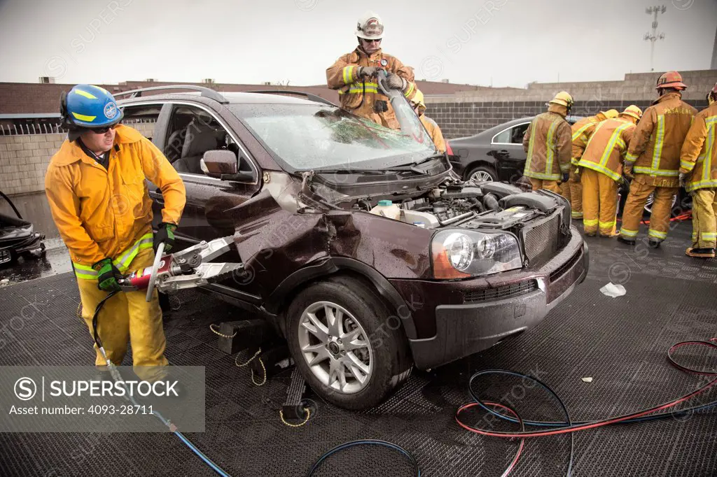 Firefighters practicing emergency procedure in car accidents