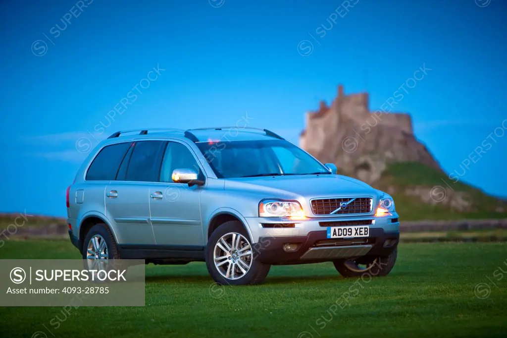 2010 Volvo XC90 parked in rural scene by castle, front 3/4