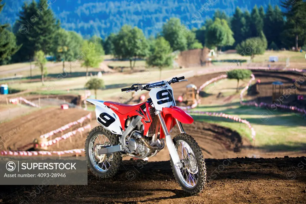 2010 Honda CRF450R in forest, front 3/4