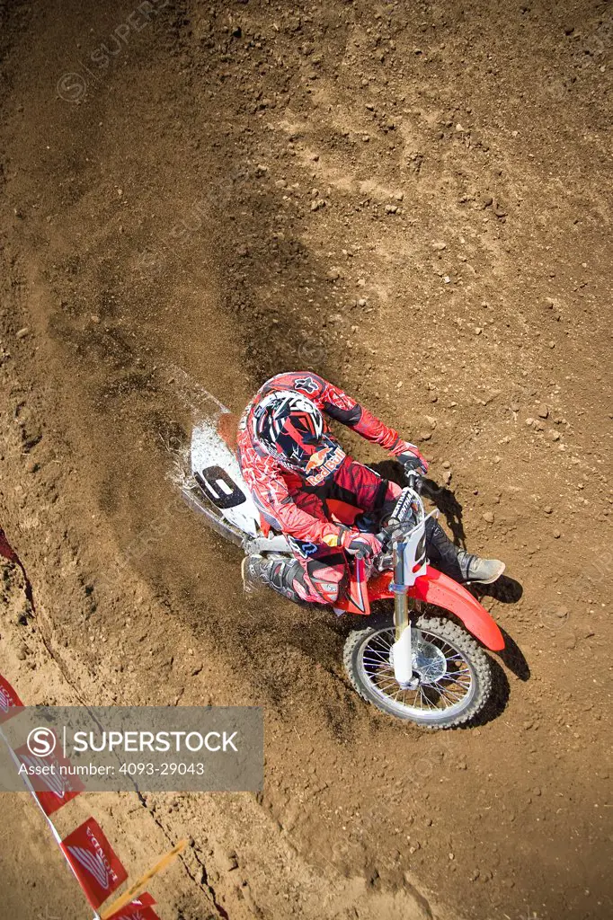 2008 Honda CRF 450R with rider Ivan Tedesco on dirt track course in forest, high angle view