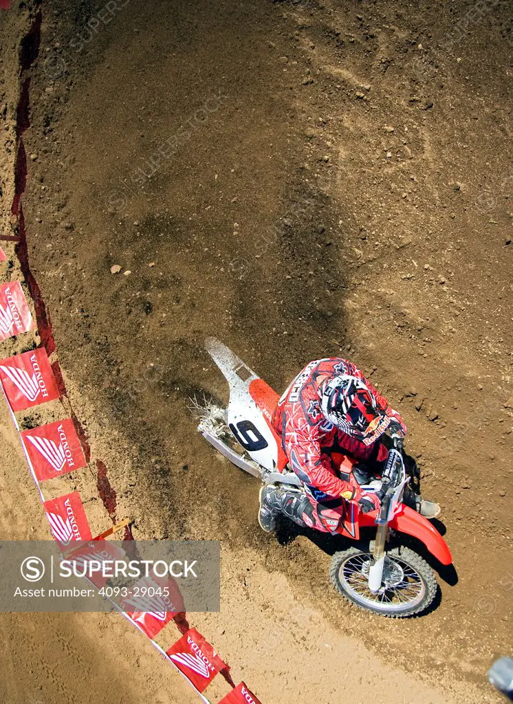 2008 Honda CRF 450R with rider Ivan Tedesco on dirt track course in forest, high angle view