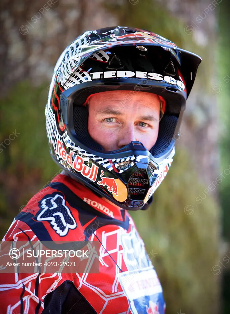 2008 Honda CRF 450R with rider Ivan Tedesco on dirt track course in forest, portrait