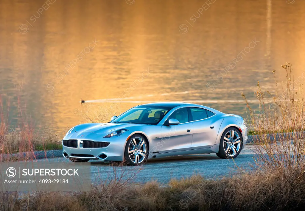 2012 Fisker Karma parked by lake, front 3/4