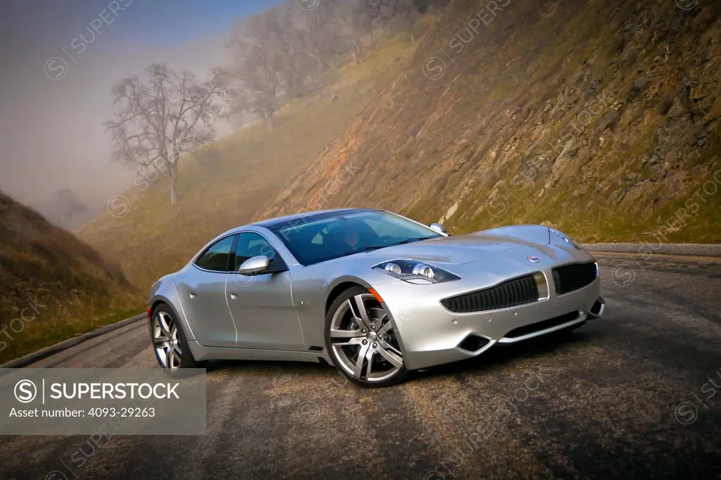 2012 Fisker Karma on country road, front 3/4