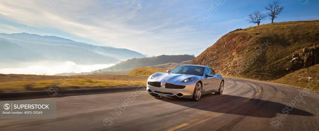 2012 Fisker Karma on country road, front 3/4