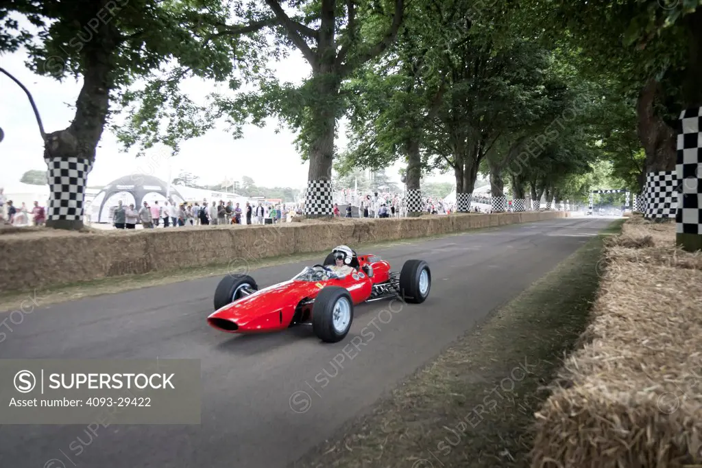Front 3/4 action of the 1964 Ferrari 158 F1 race car at the Goodwood Festival of Speed. Chassis number 006 originally driven by John Surtees. This is the sole surviving Ferrari 158.