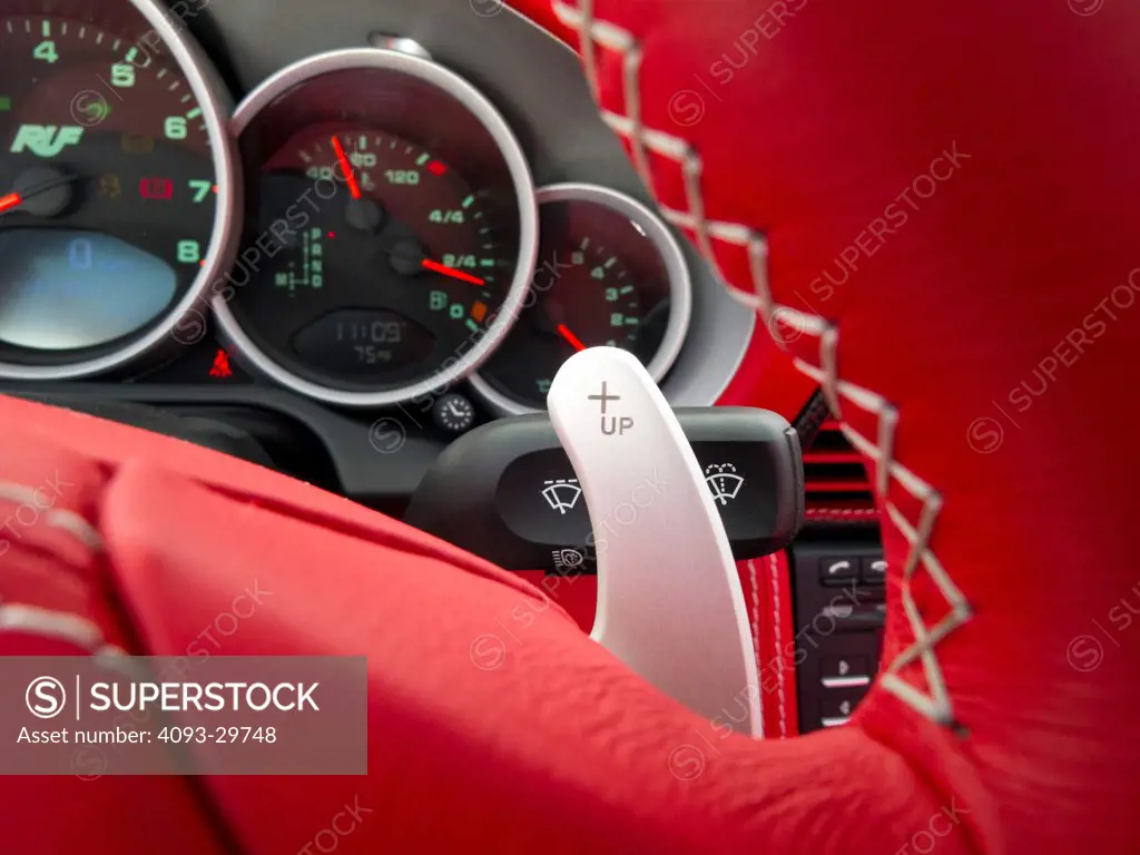 Interior of a silver 2013 Ruf RT Roadster with bright red leather showing the instrument panel and levers.