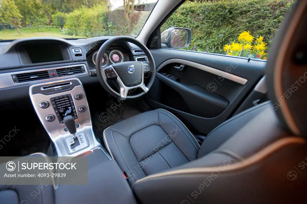 Interior of a 2013 Volvo XC60 showing the steering wheel, instrument panel, center console, dashboard and black leather seats