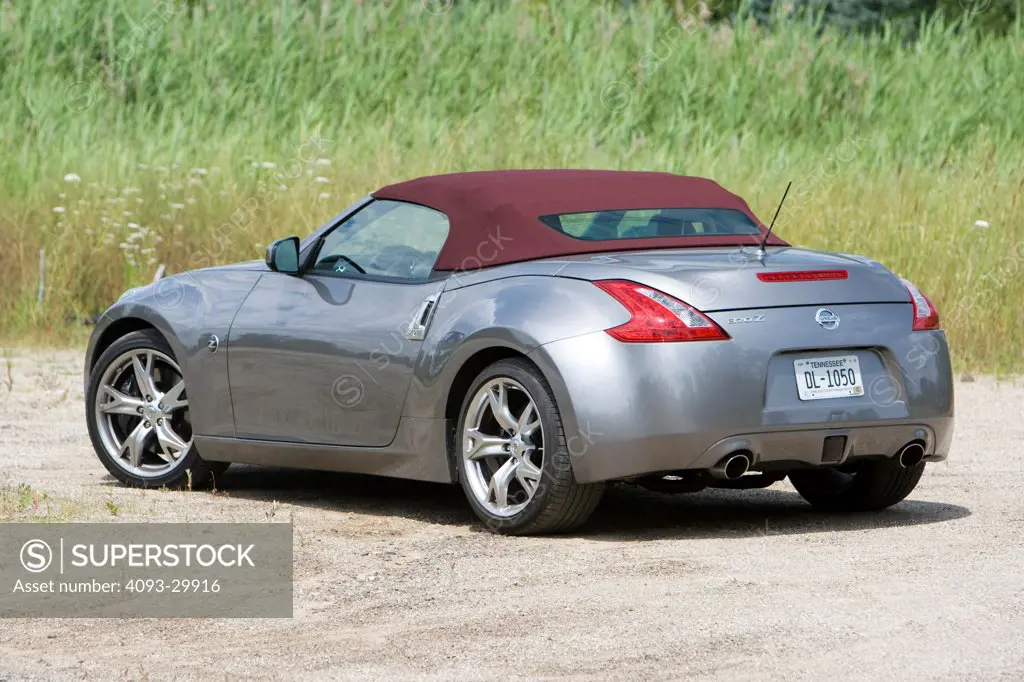 2010 Nissan 370Z Touring Roadster parked in a rural location, rear 3/4 static view