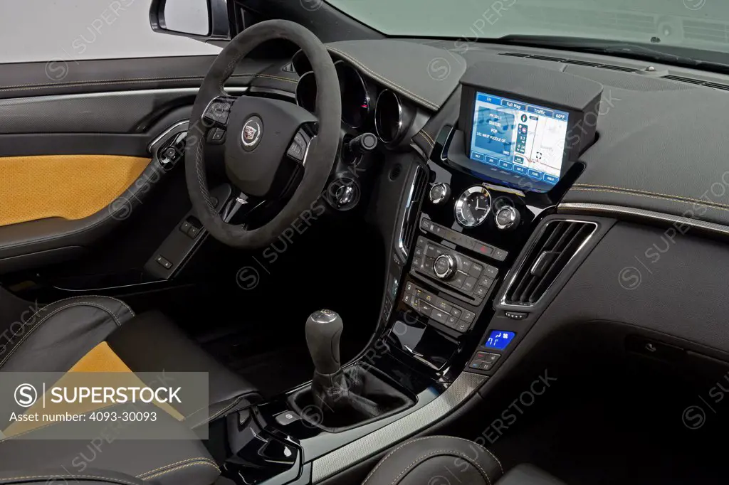 2011 Cadillac CTS-V Coupe showing the steering wheel, instrument panel, dashboard, center console, gear shift lever and GPS navigation system