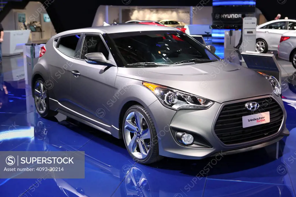 Front 3/4 static of a silver 2013 Hyundai Veloster Turbo at the 2012 Detroit International Auto Show.