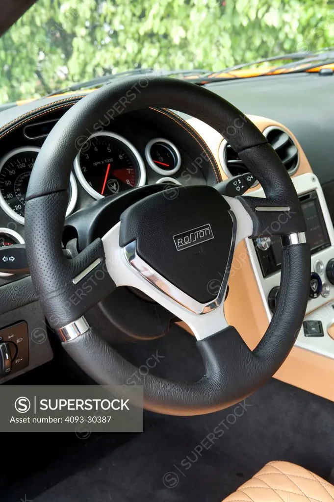 2010 Rossion Q1 sports car showing the steering wheel and instrument panel