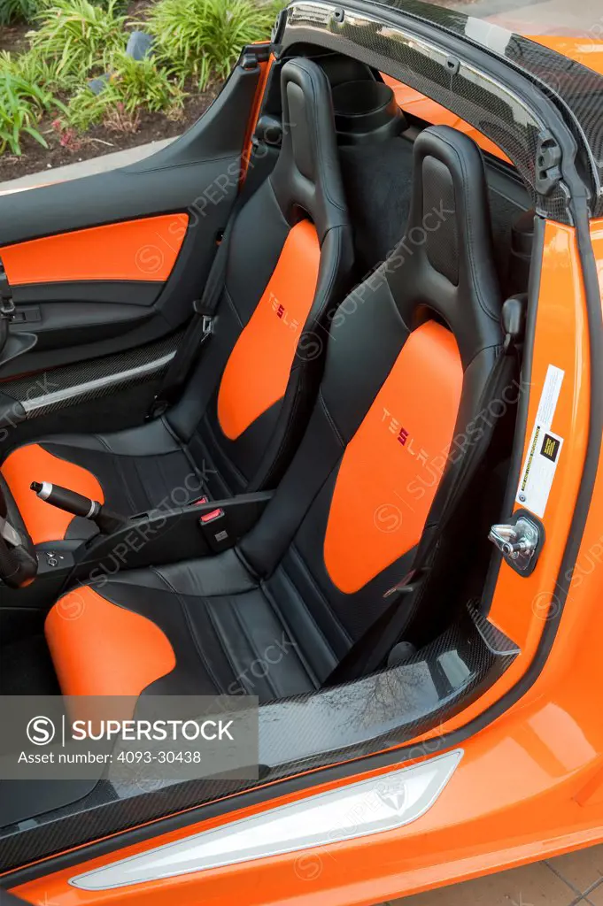 2010 Tesla RS Roadster showing the black and orange leather seats.