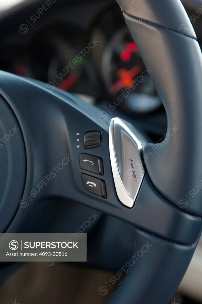 2010 Porsche Panamera Turbo showing the steering wheel buttons that operate the computer, stereo and phone
