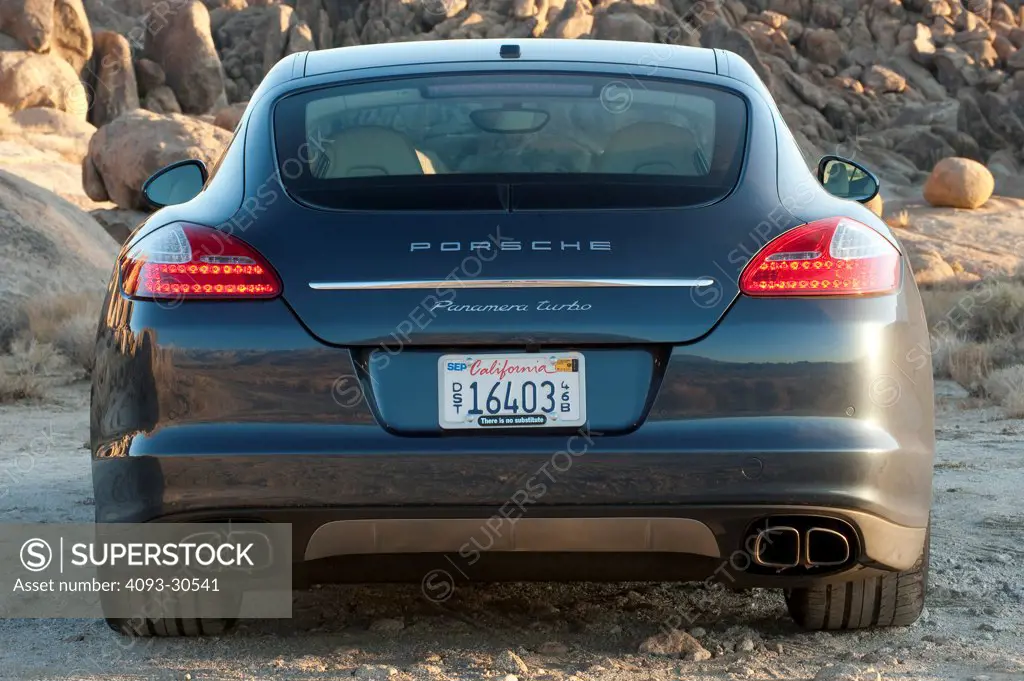 2010 Porsche Panamera Turbo parked in rocky location, rear view