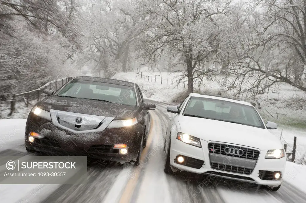 2011 Acura TL SH-AWD and 2011 White Audi S4 driving racing on a snow covered moutain road, action view