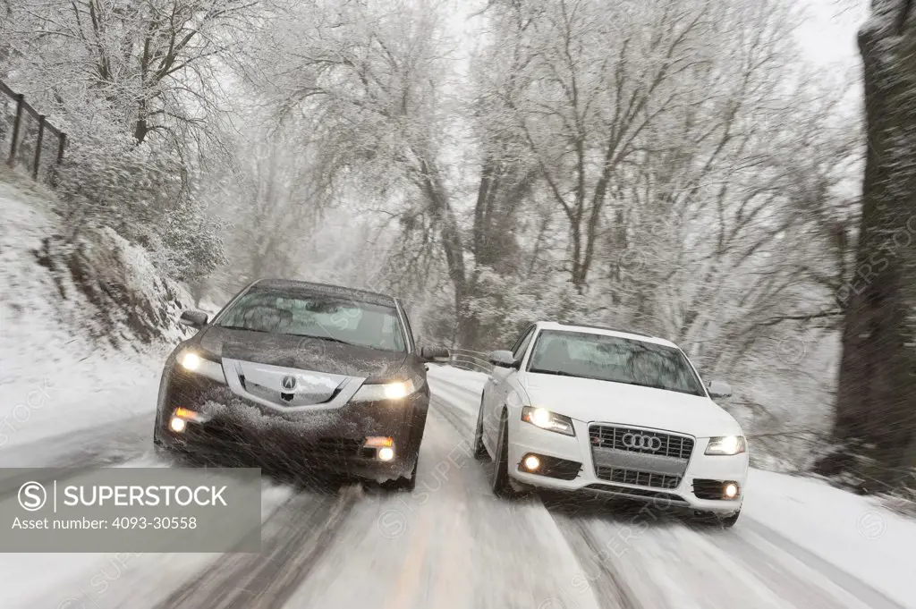 2011 Acura TL SH-AWD and 2011 White Audi S4 driving racing on a snow covered moutain road, action view