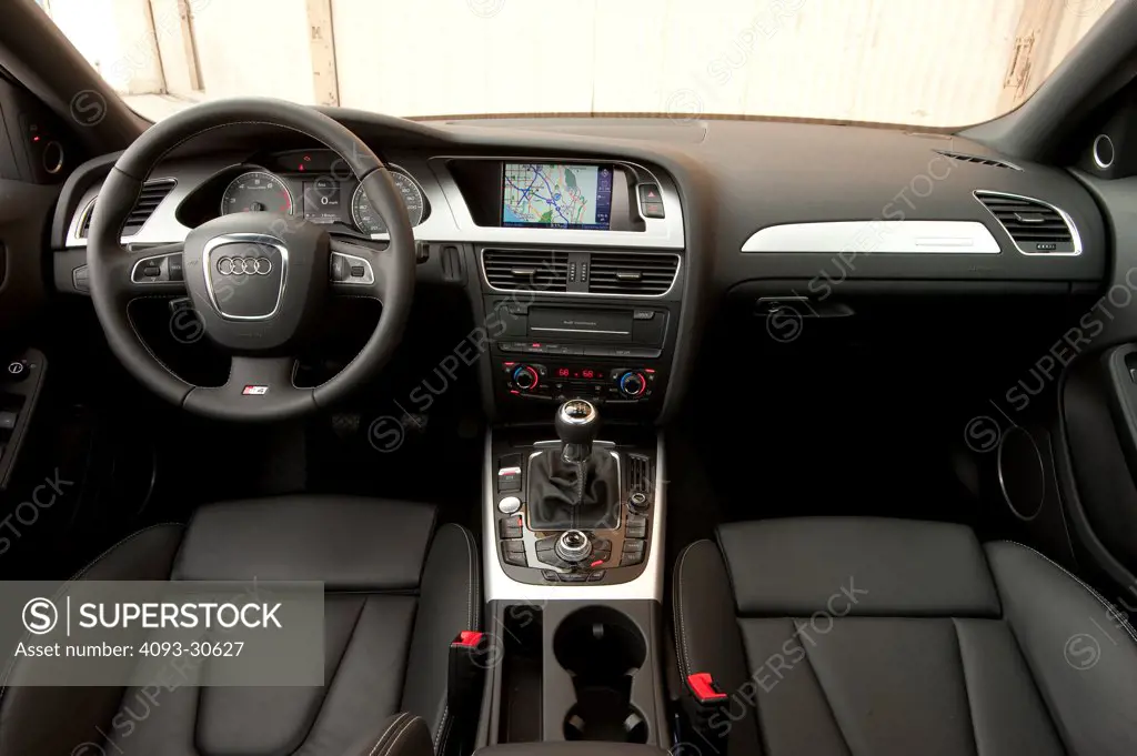 2011 Audi S4 interior showing the steering wheel, instrument panel, center console, gear shift lever, GPS navigation and front seats