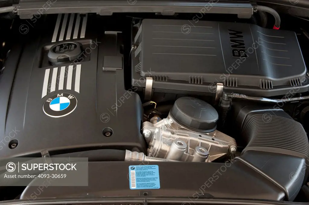 2011 Blue BMW 335i showing the inline 6 cylinder engine