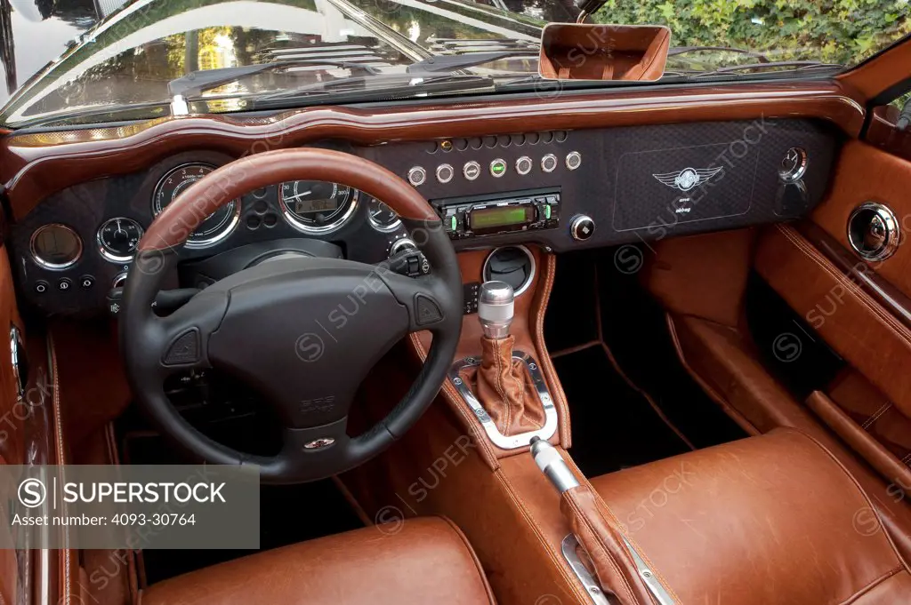 2011 Morgan Aero Supersport interior showing the steering wheel, instrument panel, dashboard, center console, gear shift lever and tan leather seats