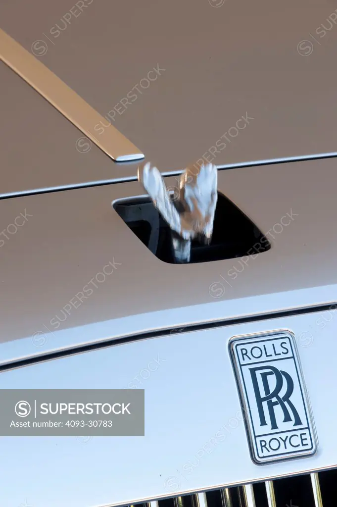 2011 Rolls Royce Ghost showing the badge logo and Flying Lady hood ornament being lowered into a secure area