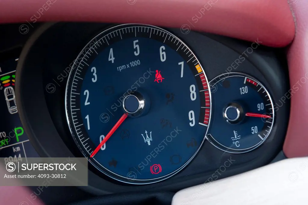 2011 Black Maserati GranCabrio showing the the instrument panel and the tachometer, interior view