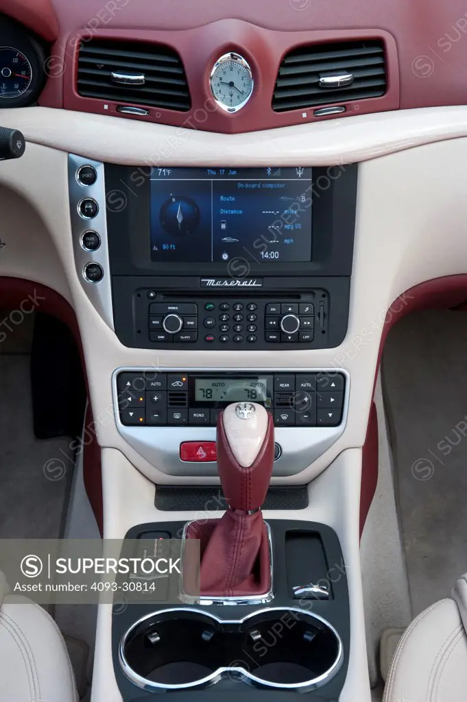 2011 Black Maserati GranCabrio showing the center console, GPS Navigation system and gear shift lever, interior view
