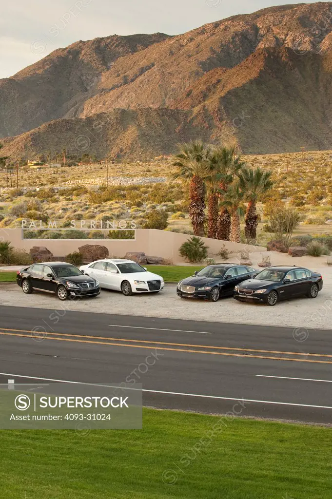 Comparison of four 2012 long wheelbase sedans, including the Audi A8 L, BMW 750Li, Hyundai Equus and Jaguar XJL parked in the desert